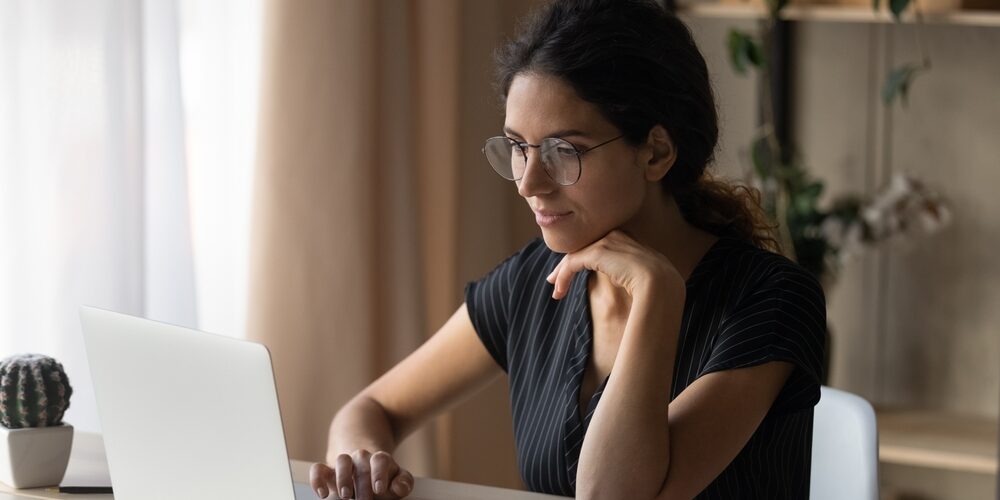 Interesting,Task.,Focused,Young,Hispanic,Woman,In,Eyewear,Sit,By Importance of Updating Business Documents When You Move